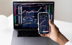 Monitoring finances on phone and laptop
