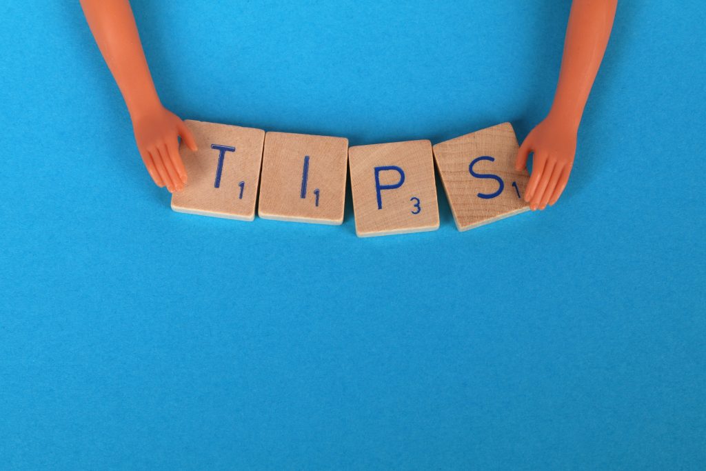 Barbie hands spell "TIPS" with blocks