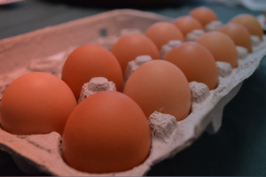 A carton of brown eggs sitting on a table