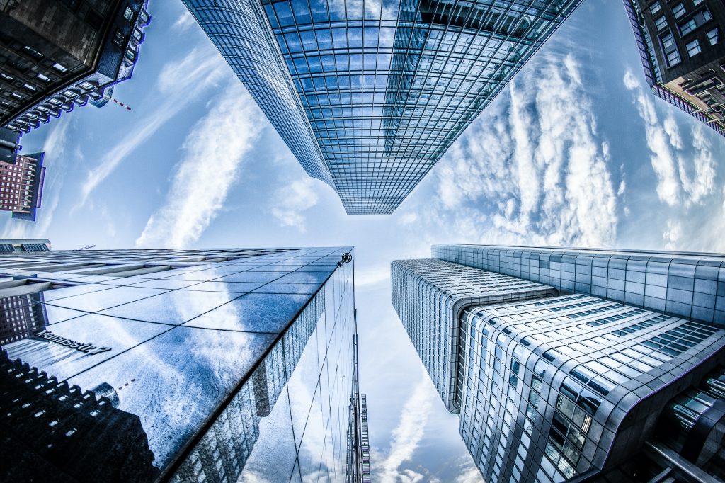 Fisheye view looking up at a group of skyscrapers in a city