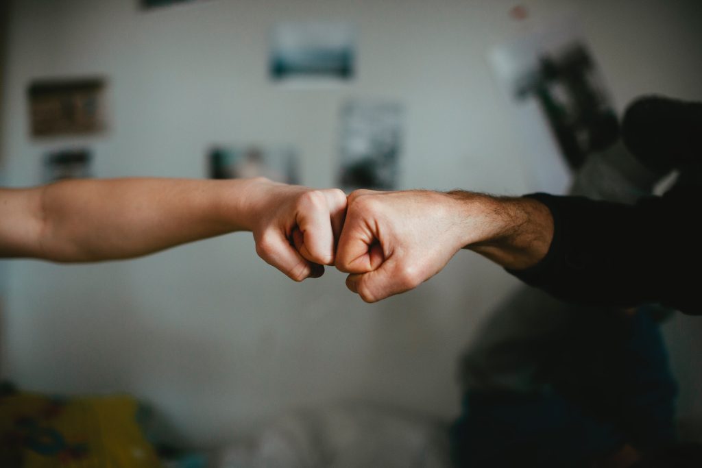 two people bump their fists