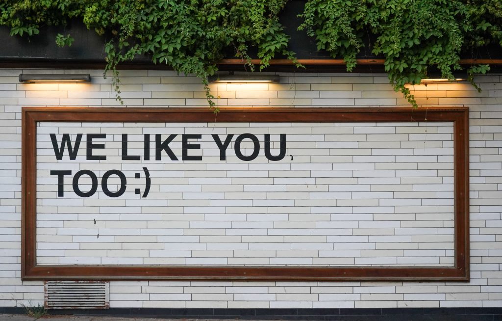 a white wall with the text "we like you too:)"