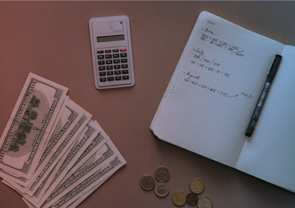a table with money, notebook, and calculator