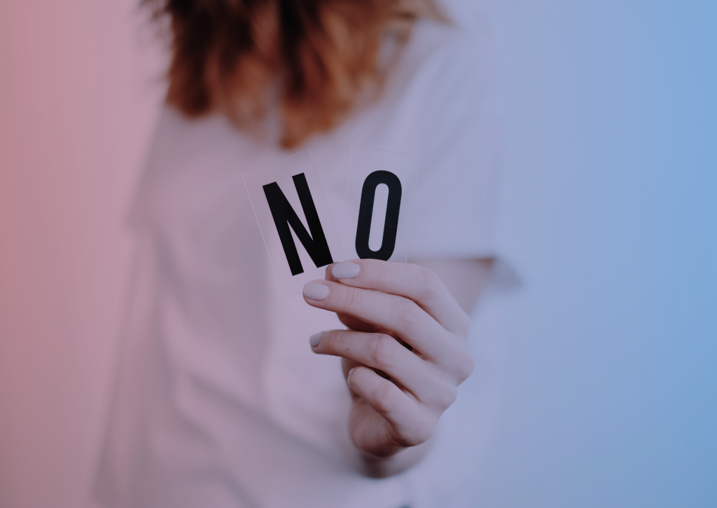 a women holds a message "no" in her hands