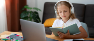 girl in headphones in front of the laptop