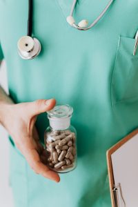 A healthcare worker holding a prescription bottle